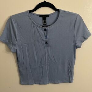 Blue ribbed top with flower shaped buttons